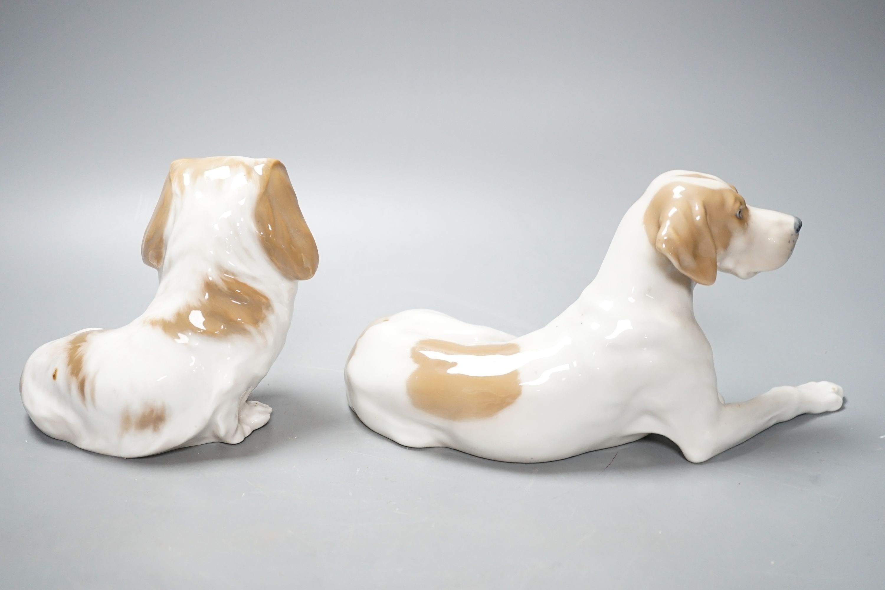 Two Royal Copenhagen figures of dogs and two Bing and Grondahl figures of dogs, largest 23 cms wide